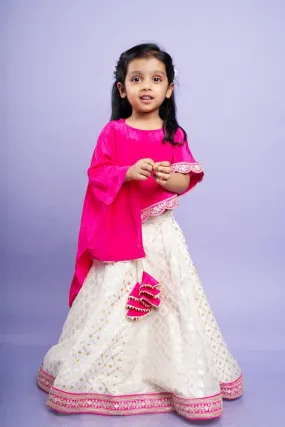 Elegant pink cape top with a white and gold lehenga, perfect for festive celebrations