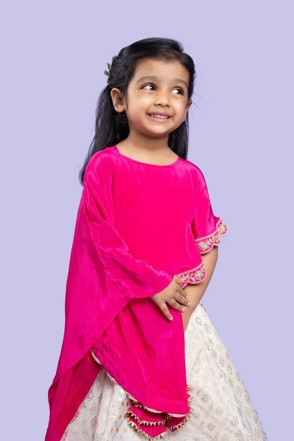 Elegant pink cape top with a white and gold lehenga, perfect for festive celebrations